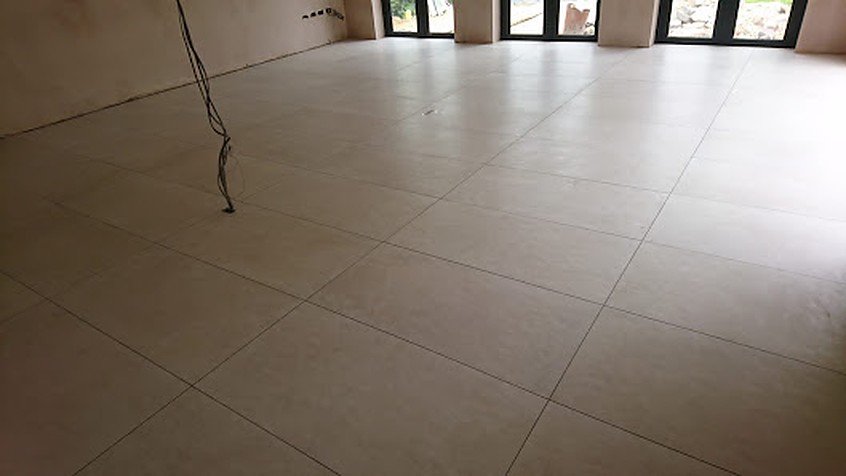 Large-format porcelain floor tiling laid in a bright open-plan living space, Abbots Langley